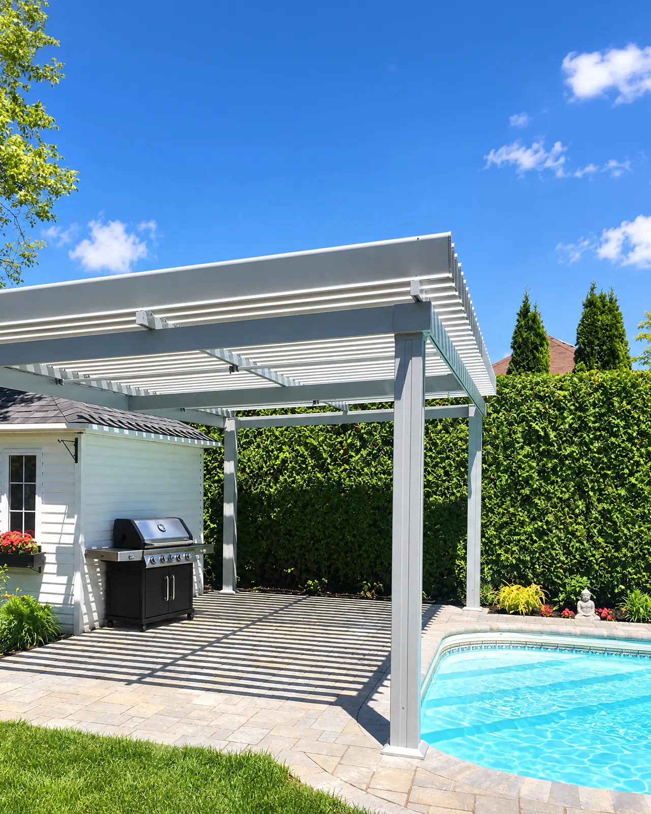 Pergola Classique grise au bord d'une piscine creusée, à côté d'un cabanon blanc et d'un barbecue