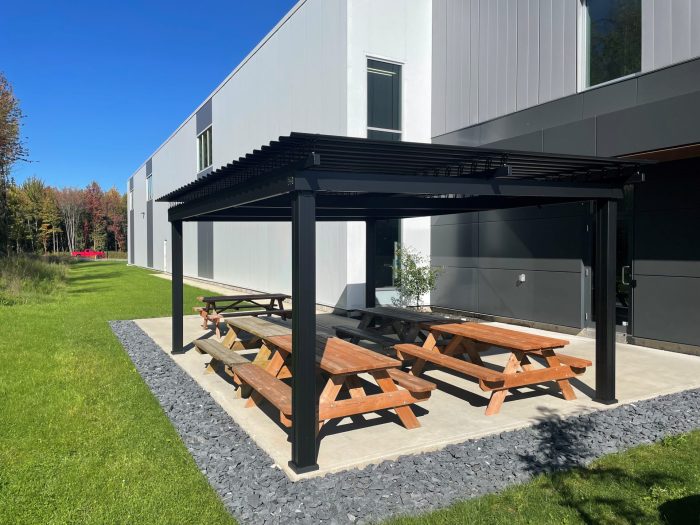 Black pergola over the picnic tables near the building, Atlas Aeronautik in Granby