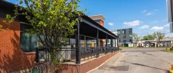 Sheltered terrace running along the brick building, Barbies Resto Bar Grill in Brossard