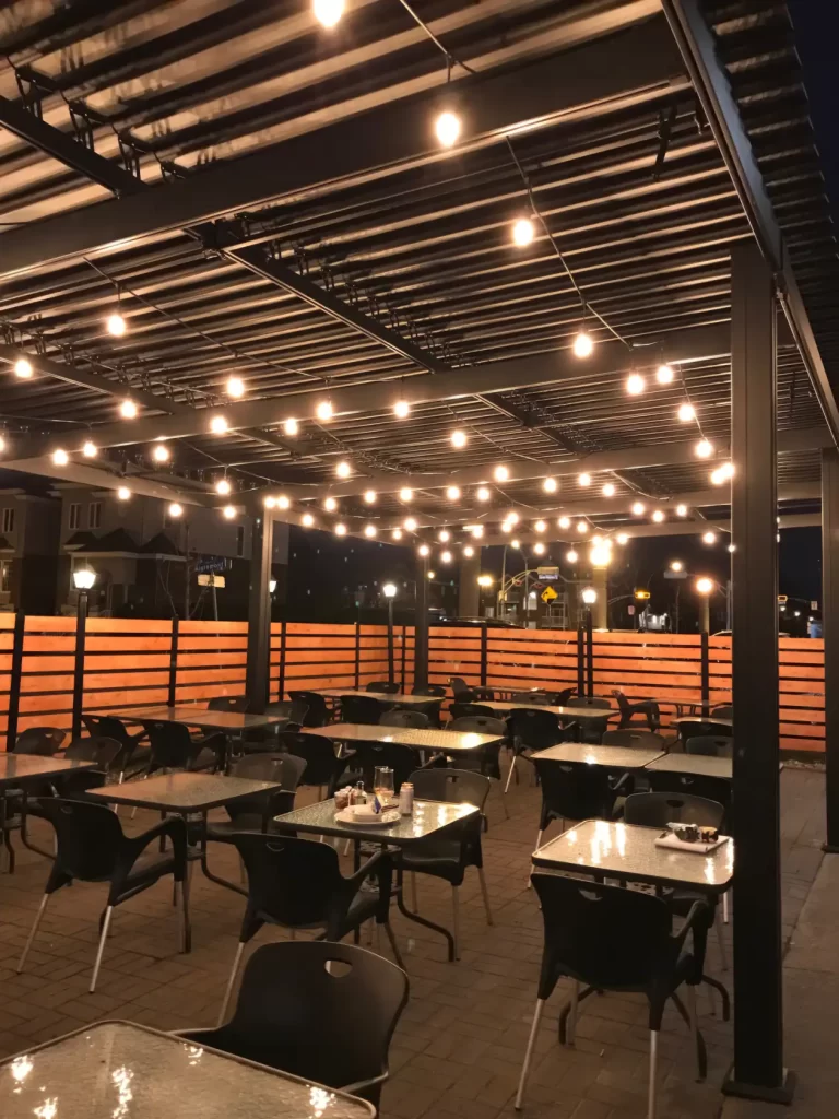 Intérieur de la terrasse couverte, guirlandes allumées le soir, Buon Gusto à Laval