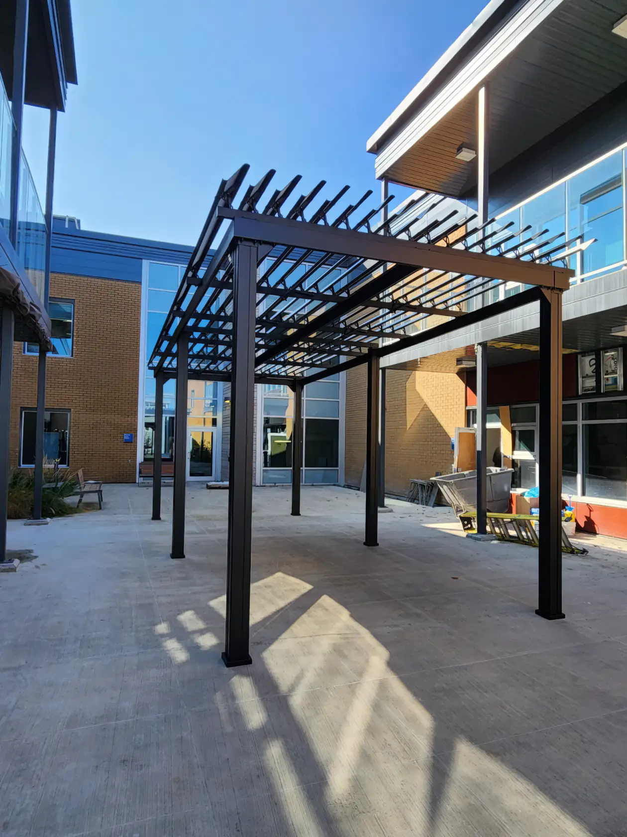 Black pergola over the care home courtyard, CHSLD de Chauffailles in Rivière-du-Loup