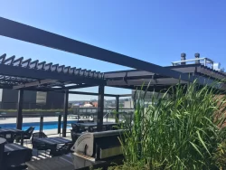 Rooftop terrace with grasses under the dark louvers, Condos Le Nordelec in Montréal