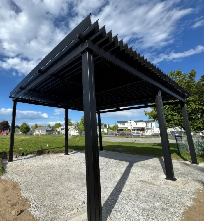 Black pergola on the schoolyard's gravel area, École Nouveau Monde in Gatineau