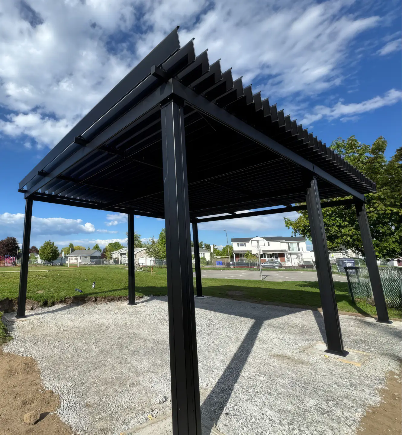 Black pergola on the schoolyard's gravel area, École Nouveau Monde in Gatineau