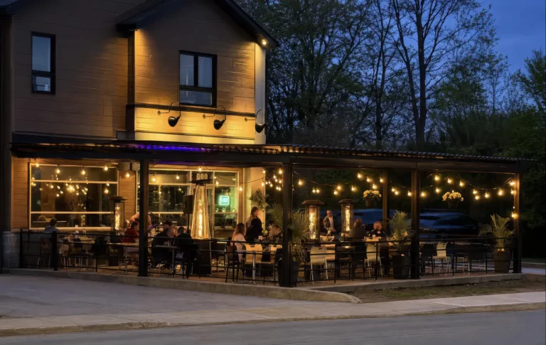 The restaurant and its lit terrace at dusk, Le Décante in Lavaltrie