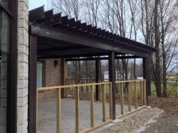 Black louvered walkway alongside the building, Saint-Alphonse-de-Granby town hall