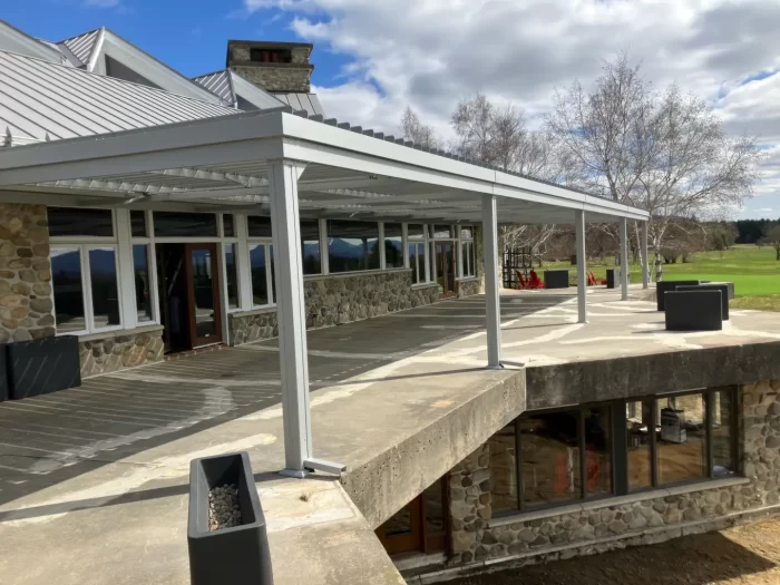 Long white louvered canopy in front of the lodge, Owl's Head Ski & Golf in Mansonville