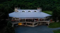Aerial view of the lodge and its covered terrace in the forest, Owl's Head Ski & Golf in Mansonville