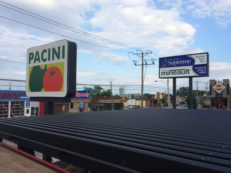 Black louvered roof from below, under the sign, Pacini in Gatineau