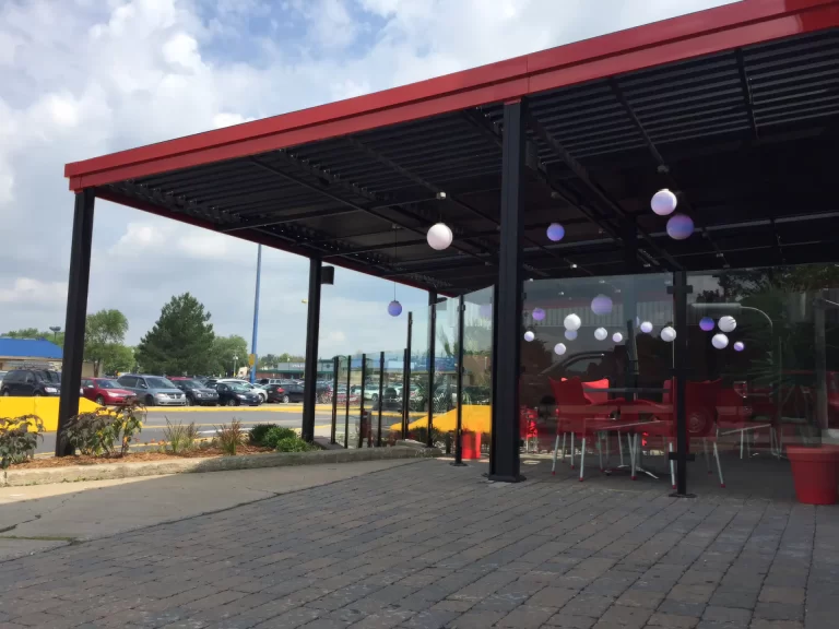 Black pergola trimmed in red over the terrace, Pacini in Longueuil