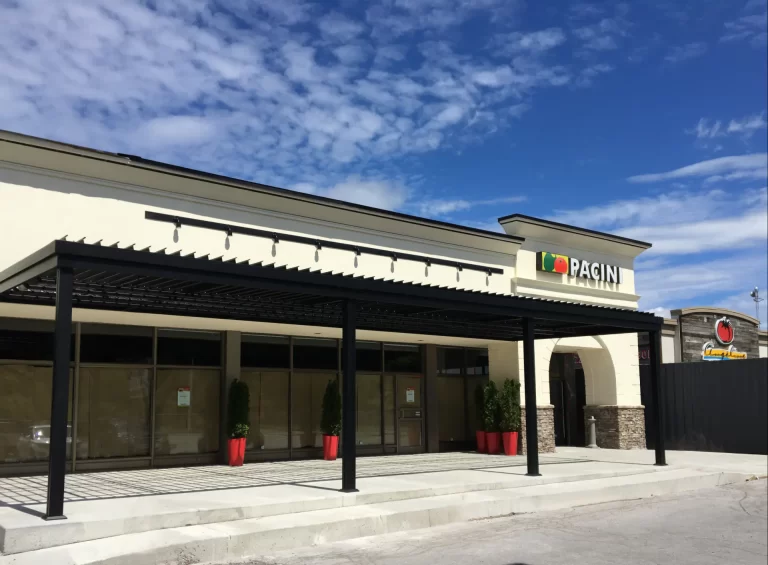 Black pergola running along the façade beneath the sign, Pacini in Trois-Rivières