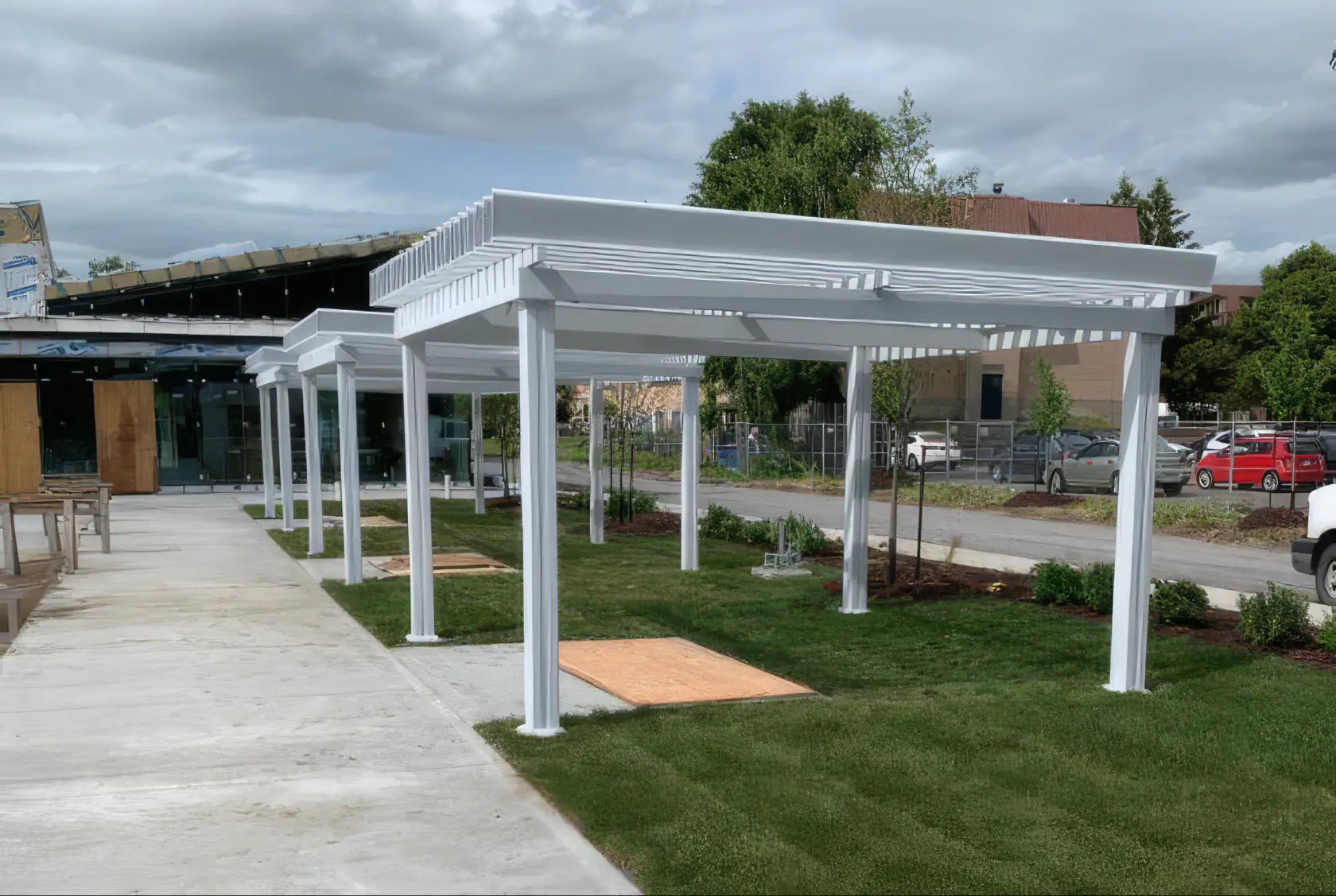 White pergola over the park's landscaped area, Parc Champlain in Brossard