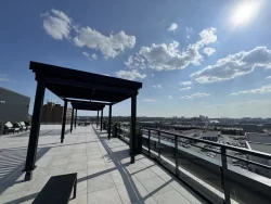 Terrasse de toit avec pergolas et chaises longues face à la ville, Station 27 à Ottawa