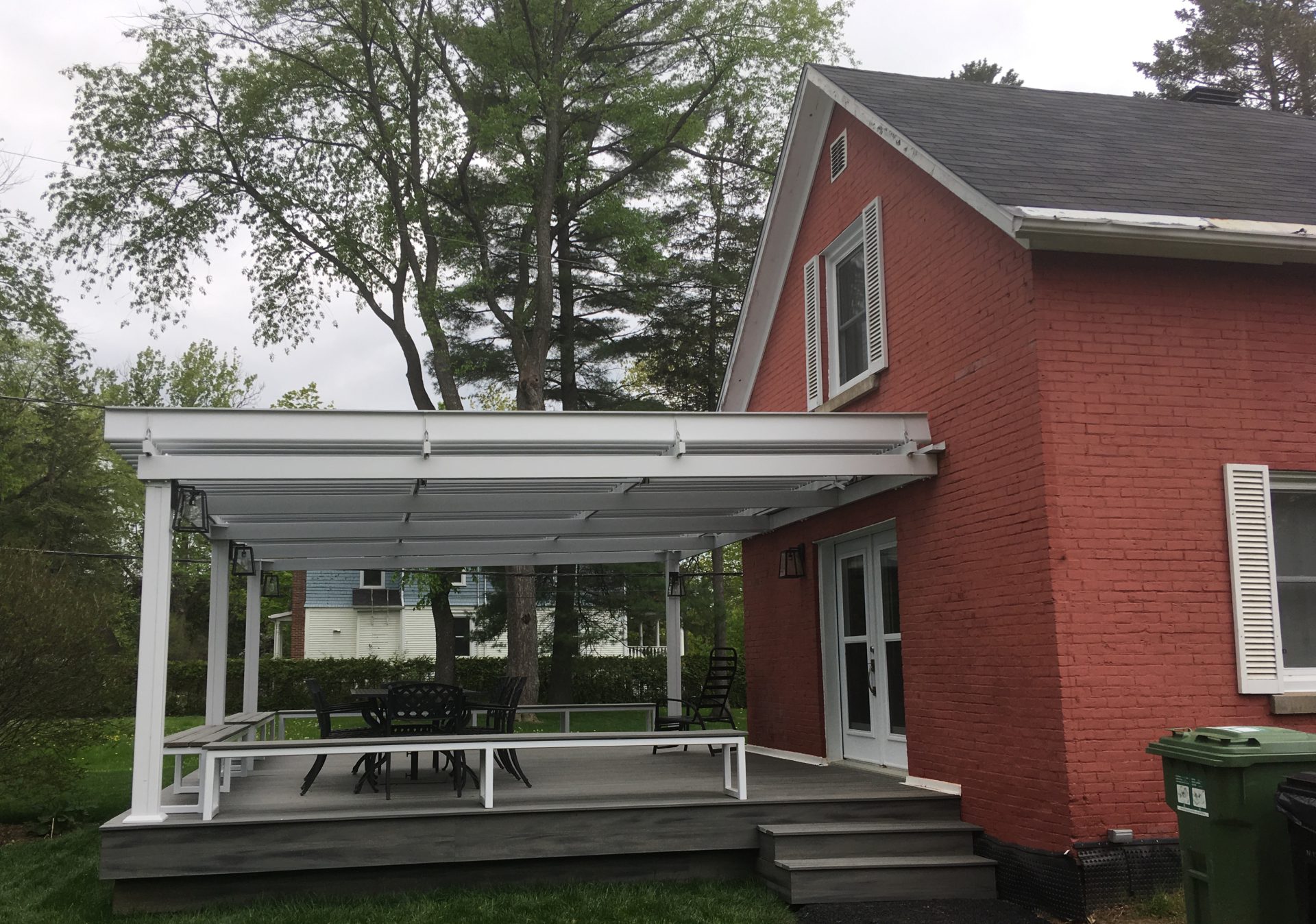 White pergola against a red brick house, Bishop's University in Sherbrooke